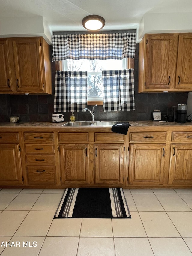 510 Ashcroft Ave, Cresson, PA 16630 - kitchen with a sink, light tile patterned floors, tasteful backsplash, and brown cabinets