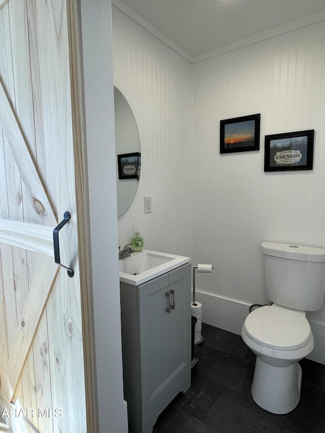 bathroom featuring toilet and vanity