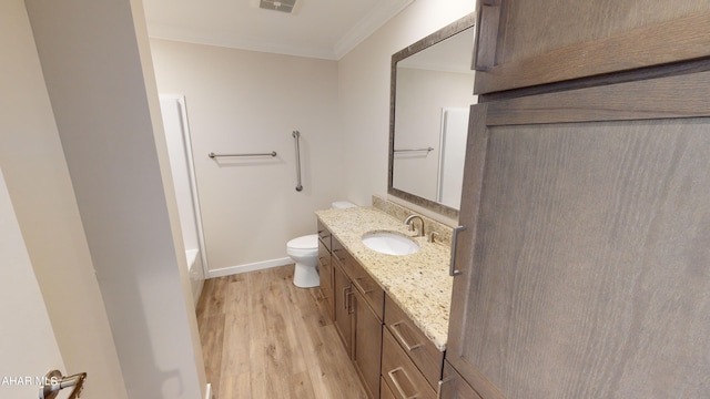 bathroom with ornamental molding, vanity, toilet, and hardwood / wood-style floors