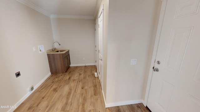 laundry area featuring light hardwood / wood-style floors, sink, ornamental molding, and hookup for an electric dryer