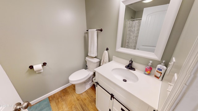 bathroom with hardwood / wood-style floors, vanity, and toilet