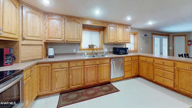 kitchen featuring kitchen peninsula, sink, and appliances with stainless steel finishes