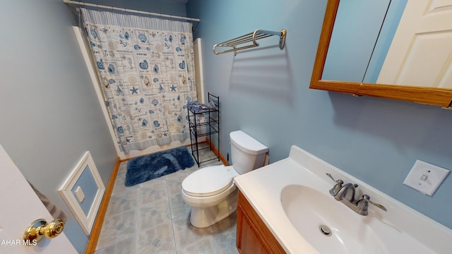 bathroom with vanity, curtained shower, and toilet