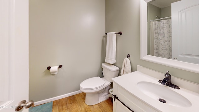 bathroom featuring hardwood / wood-style floors, vanity, and toilet