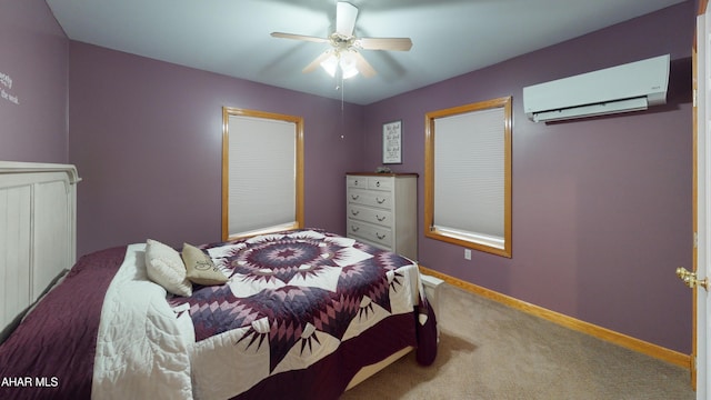 bedroom with a wall mounted air conditioner, ceiling fan, and carpet