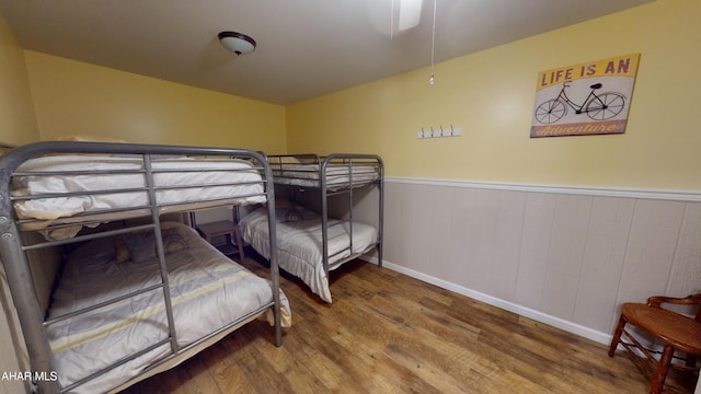 bedroom with ceiling fan and wood-type flooring