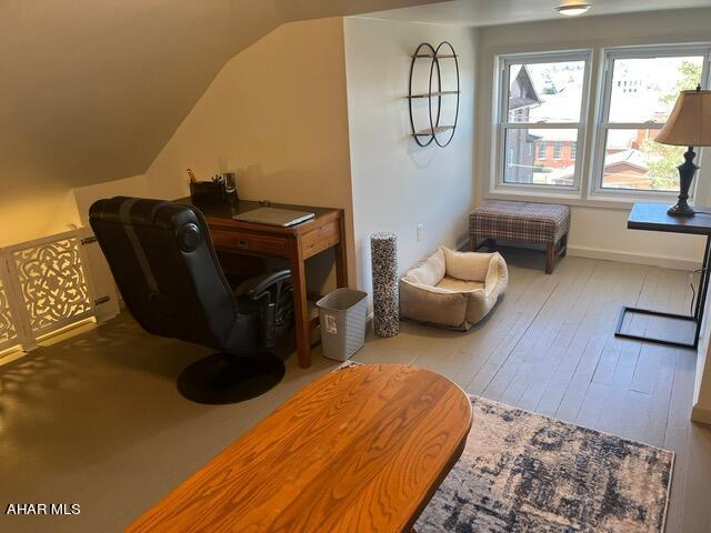 living area with light hardwood / wood-style floors and lofted ceiling