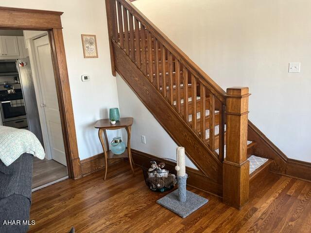 stairs with hardwood / wood-style flooring