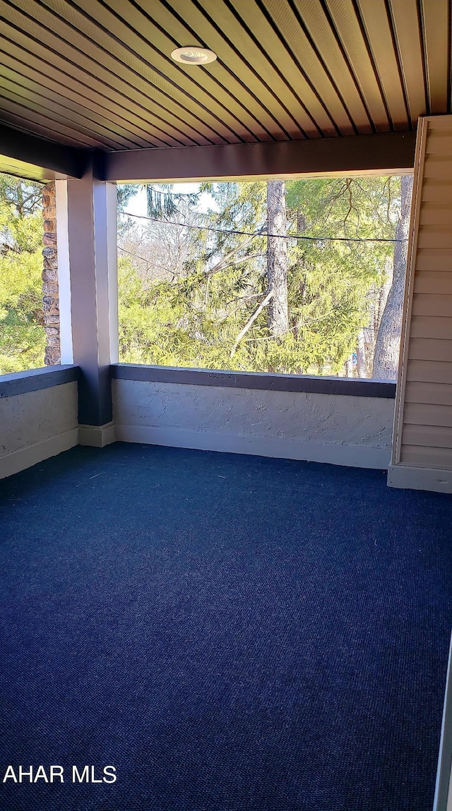 unfurnished sunroom with wood ceiling