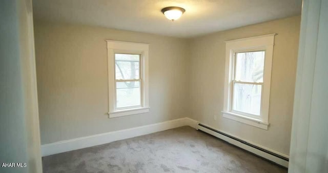 spare room featuring carpet floors and baseboard heating