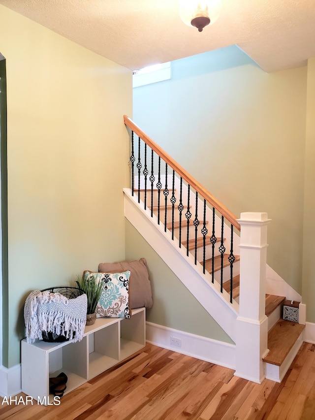 staircase featuring hardwood / wood-style flooring