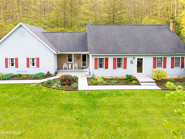 6334 Black Valley Rd, Everett, PA 15537 - cape cod home featuring a chimney, covered porch, a wooded view, a shingled roof, and a front yard