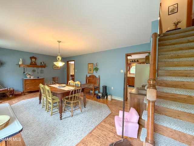 6334 Black Valley Rd, Everett, PA 15537 - dining room featuring baseboards, stairway, and light wood-type flooring
