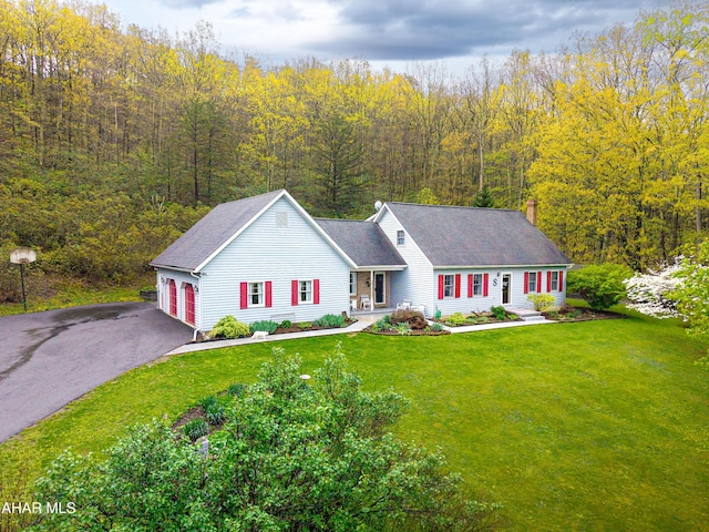 6334 Black Valley Rd, Everett, PA 15537 - single story home with a front yard, aphalt driveway, a view of trees, and an attached garage