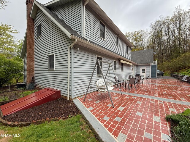 6334 Black Valley Rd, Everett, PA 15537 - back of house featuring a patio and a chimney