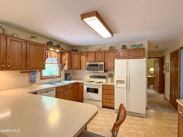6334 Black Valley Rd, Everett, PA 15537 - kitchen with brown cabinets, white appliances, light countertops, and a sink