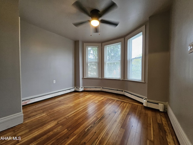 unfurnished room with wood-type flooring, a baseboard radiator, and ceiling fan