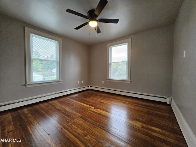 empty room with dark hardwood / wood-style floors, ceiling fan, and baseboard heating