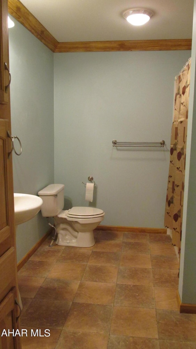 bathroom with toilet and crown molding