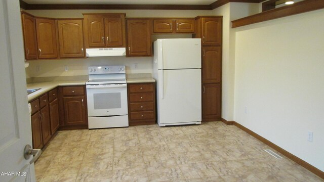 kitchen featuring white appliances and ornamental molding