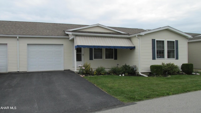 single story home featuring a garage and a front yard