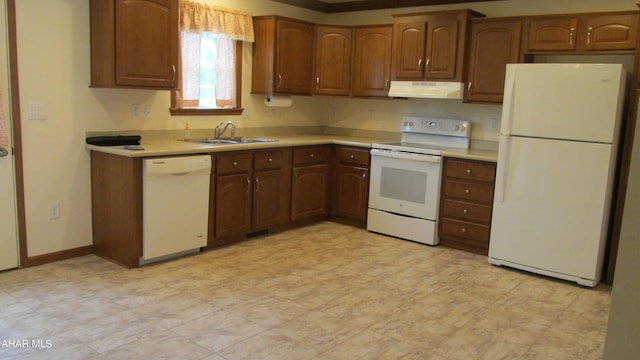 kitchen featuring white appliances and sink