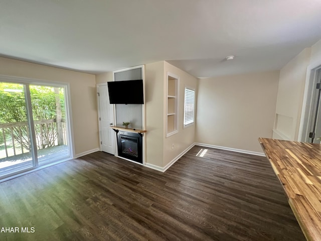 unfurnished living room featuring dark hardwood / wood-style floors