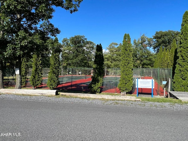 view of front facade featuring tennis court