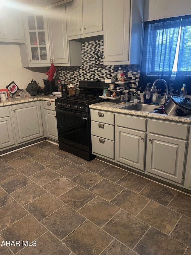 kitchen featuring sink, white cabinetry, black range with gas cooktop, and tasteful backsplash