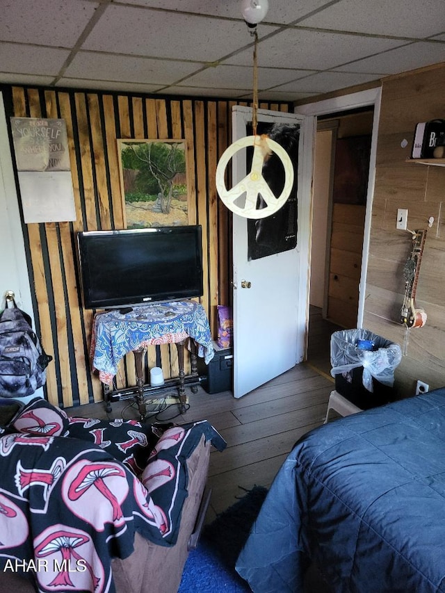 2521 Holland Ave, Huntingdon, PA 16652 - bedroom with wooden walls, a drop ceiling, and hardwood / wood-style flooring