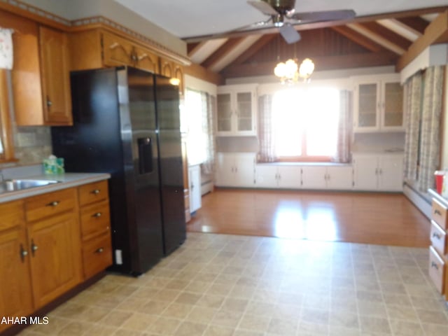 kitchen featuring an inviting chandelier, vaulted ceiling with beams, light countertops, brown cabinets, and black refrigerator with ice dispenser