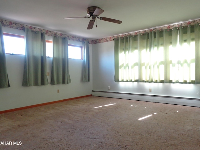 unfurnished room with baseboards, a ceiling fan, carpet, and a baseboard radiator