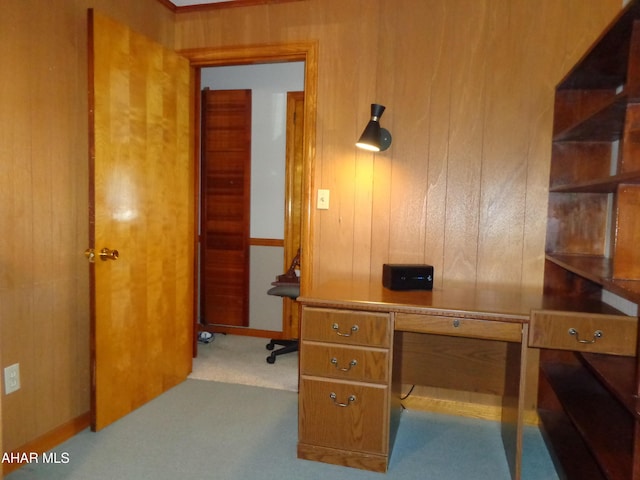 office space featuring carpet flooring and wood walls