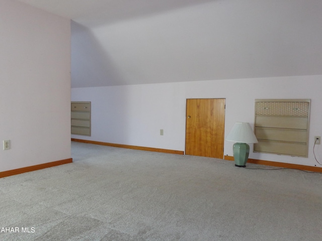 bonus room with vaulted ceiling, carpet, and baseboards