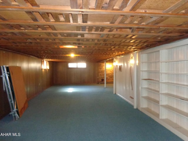 basement with wooden walls and carpet floors