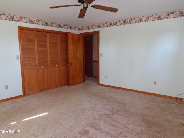 unfurnished bedroom with a closet, carpet flooring, and baseboards