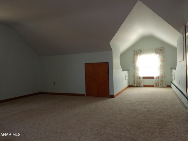 bonus room featuring a baseboard radiator, baseboards, and vaulted ceiling