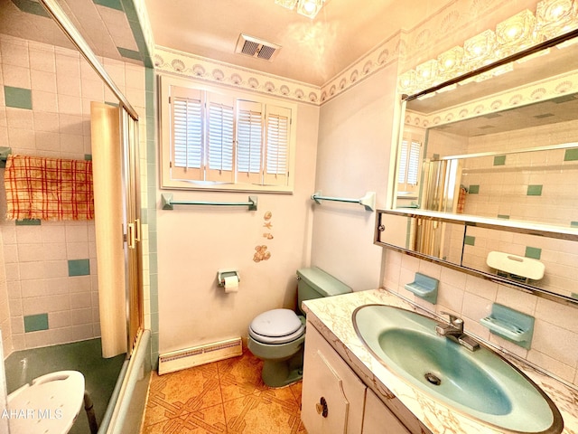 bathroom featuring visible vents, toilet, a baseboard heating unit, bath / shower combo with glass door, and vanity