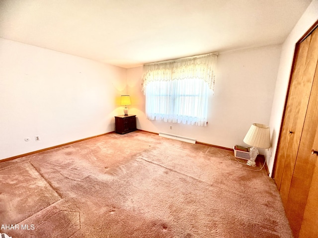 unfurnished bedroom with a closet, carpet, baseboards, and baseboard heating