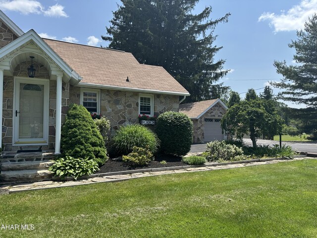 328 Avalon Rd, Altoona, PA 16601 - view of side of home featuring stone siding, a lawn, roof with shingles, and entry steps