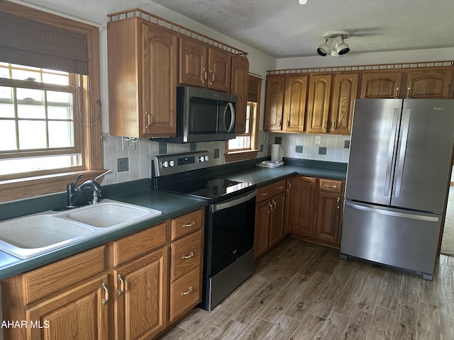328 Avalon Rd, Altoona, PA 16601 - kitchen with appliances with stainless steel finishes, wood finished floors, decorative backsplash, dark countertops, and brown cabinets