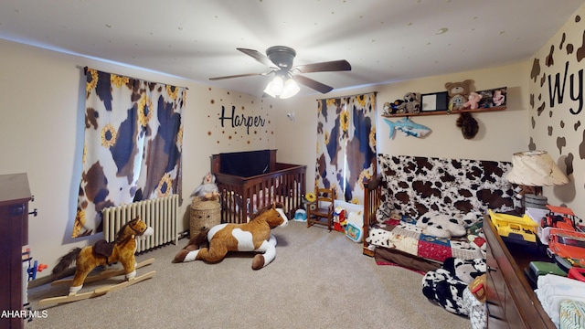 carpeted bedroom featuring radiator and ceiling fan