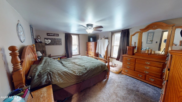 carpeted bedroom featuring multiple windows and ceiling fan