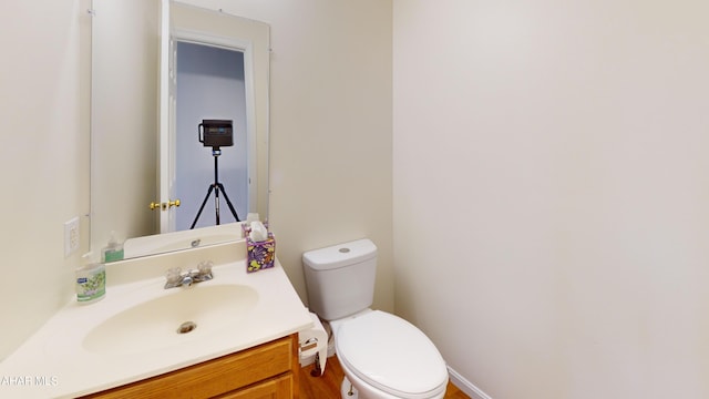 bathroom featuring toilet and vanity