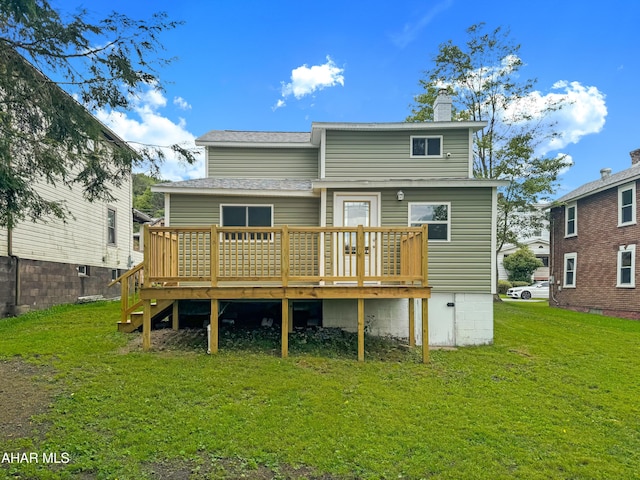 back of house with a lawn and a deck