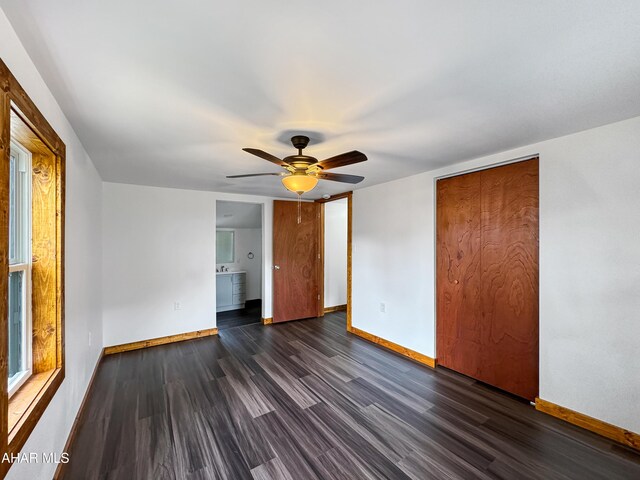 empty room featuring ceiling fan and dark wood-type flooring