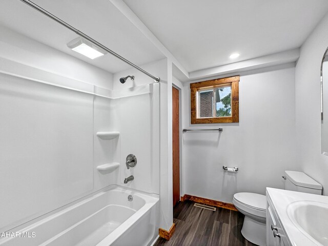 full bathroom featuring vanity, hardwood / wood-style flooring, toilet, and shower / bathtub combination