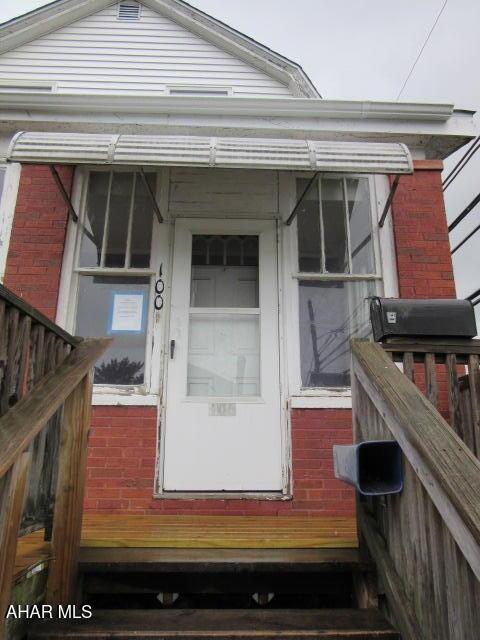 property entrance featuring brick siding