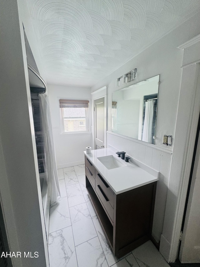 5017 Highland Park Ave, Altoona, PA 16602 - bathroom featuring marble look tiles, vanity, and shower / bath combo with shower curtain