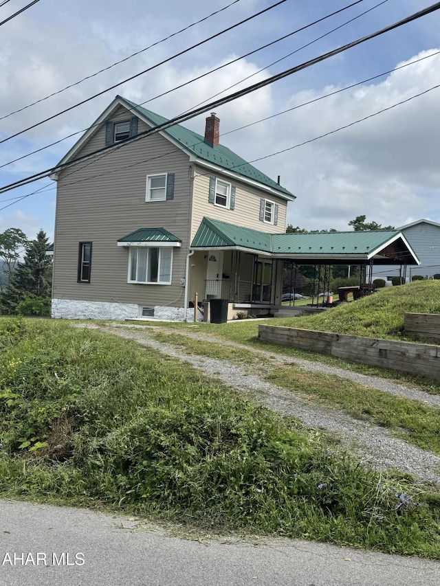 5017 Highland Park Ave, Altoona, PA 16602 - view of front facade with driveway, a chimney, and a metal roof
